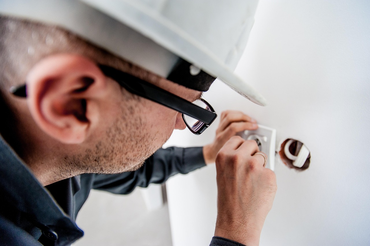 An After Dark electrician at work on a household switchboard.